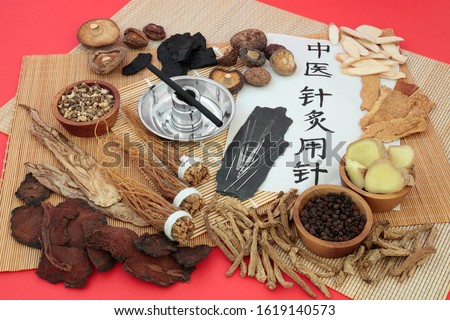 Chinese herbal medicine with herbs used as a tonic, acupuncture needles, moxa stick & script on rice paper. Translation reads as acupuncture needles used in traditional Chinese medicine.