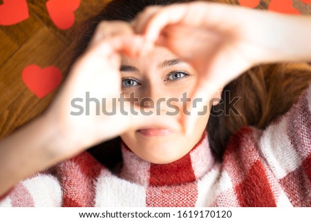 Beautiful woman showing heart with two hands