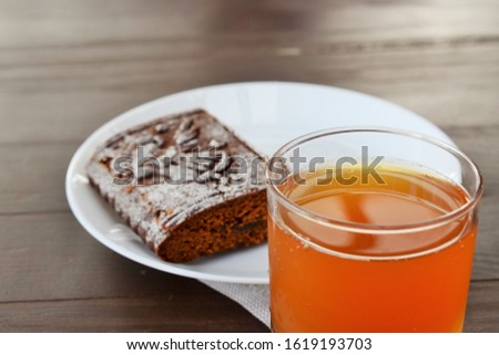 Breakfast. A glass of delicious peach juice and gingerbread on a table in a cafe