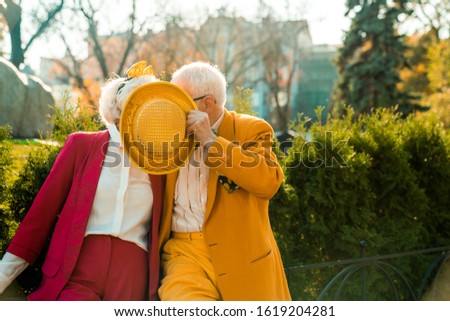 Waist up of funny elderly couple in the park stock photo