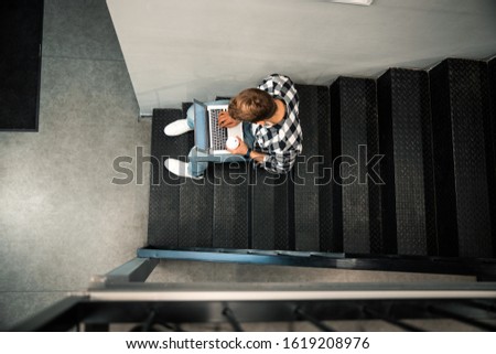 Top view of male freelancer looking on screen while holding hot drink stock photo