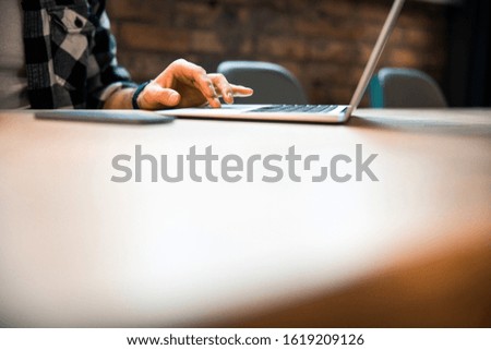 Cropeed photo of male freelancer working in co-working space stock photo