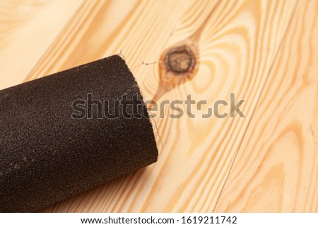 Sandpaper on a wooden background. Stock photo with place for caption.