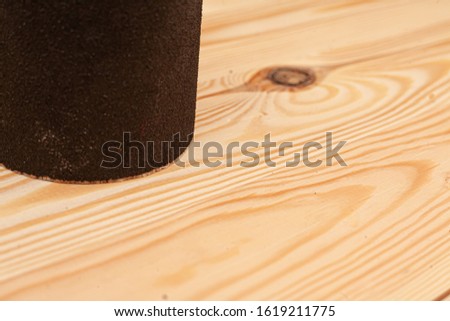 Sandpaper on a wooden background. Stock photo with place for caption.