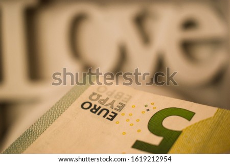 Five euro bill with love text as background