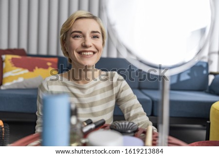 Waist up of smiling beautiful lady ready to make video stock photo