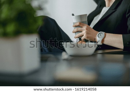 Close up of young woman with thermo cup in the office stock photo