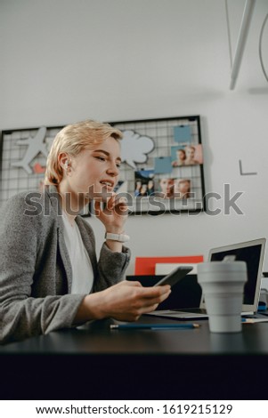 Cropped photo of smiling woman with headphone using smartphone stock photo