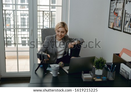 Waist up of happy young blogger making video stock photo