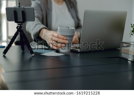 Cropped photo of female hand taking coffee while working in the office stock photo