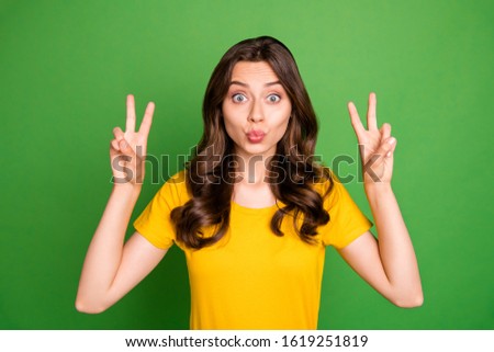 Close-up portrait of her she nice attractive lovely coquettish cheerful wavy-haired girl showing v-sign sending kiss having fun fooling isolated on bright vivid shine vibrant green color background