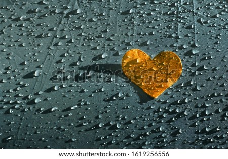 Orange heart on raindrops background, Valentine's Day background, health and cardio concept