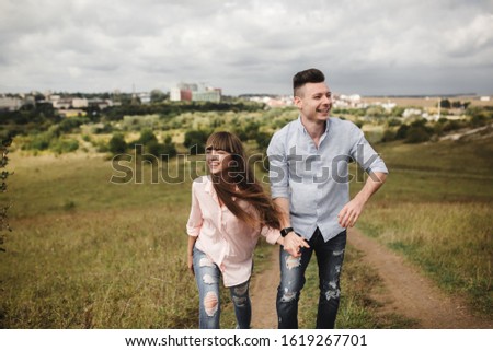 Young fun romantic couple is having fun around the city in summer sunny day. Enjoying spending time together in holiday. Valentine's Day