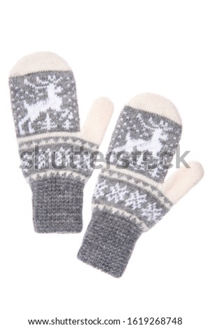 Warm woolen knitted mittens isolated on white background. Gray knitted mittens with pattern.