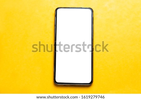 Mobile smartphone isolated on yellow background