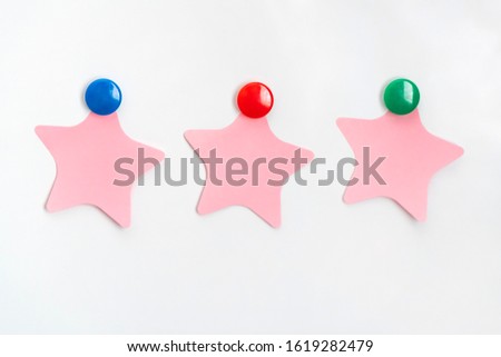 Three star paper stickers on white background.