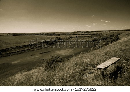 Bench by the river vintage sepia style, old photo