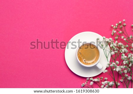 Womens day 8 March concept. Morning coffee, white gypsophila flowers on pink pastel background, flatlay, copy space, top view