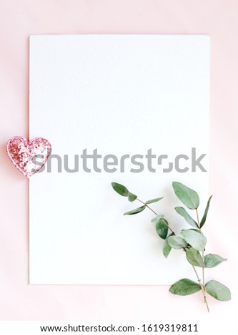  Background with copy space blank on pink background with pink glittered hearts, eucalyptus branch. White paper top view, flat lay, minimal style. Moke up card.                                