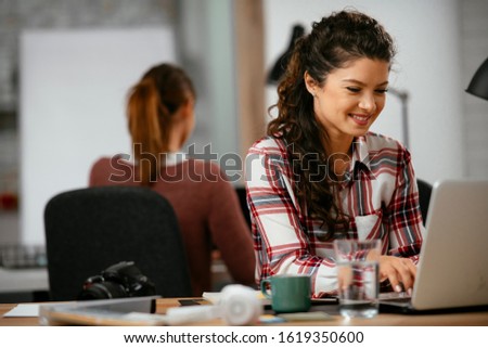 Young beautiful businesswoman working on a new project on her workplace at the office space. 