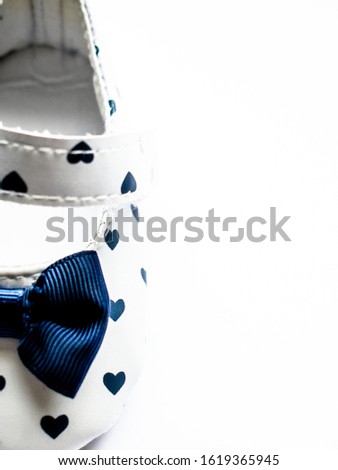 Baby shoe in hearts pattern