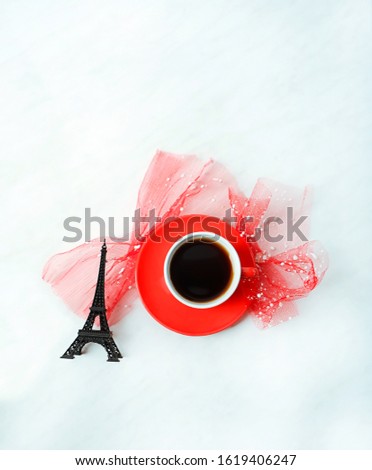 red cup of black coffee, eiffel tower on white background. romantic minimal composition. breakfast in Paris. Valentine's day concept. copy space