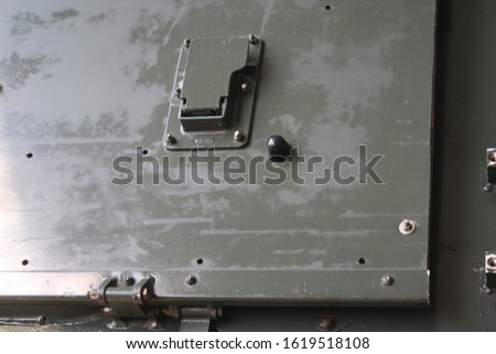 Closeup photo of  metal armored tank hatchway.