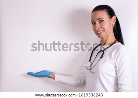 friendly doctor woman with stethoscope over white background