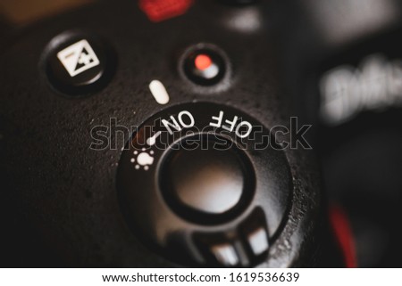 Shallow depth of field and macro image with the shutter button of a professional DSLR photo camera