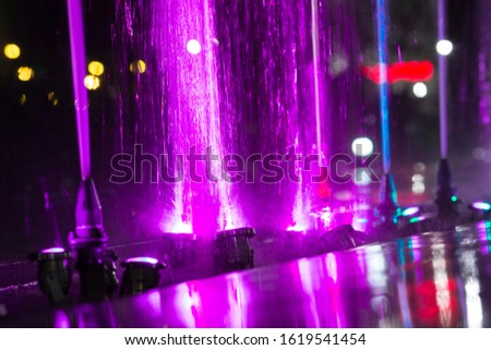 Water jets propelled with pink reflections.