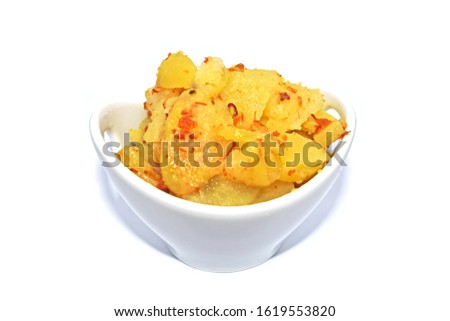Roasted mashed potatoes with onions served in a small bow isolated on a white background