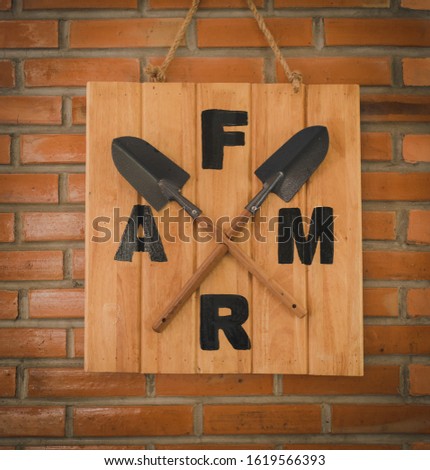 The wooden sign on the brick wall was labeled as Farm.