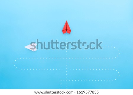 Business concept for new ideas creativity and innovative solution, Red paper plane in one individual pointing in the different way