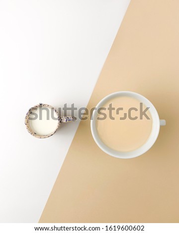 Coffee and milk on white beige bacground on a concept picture