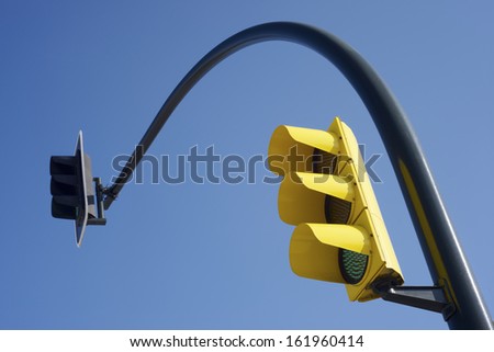 yellow traffic light and clear blue sky