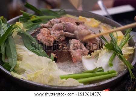 Thai barbecue buffet grill pork on hot pan it called: Moo-Kra-Ta Royalty-Free Stock Photo #1619614576