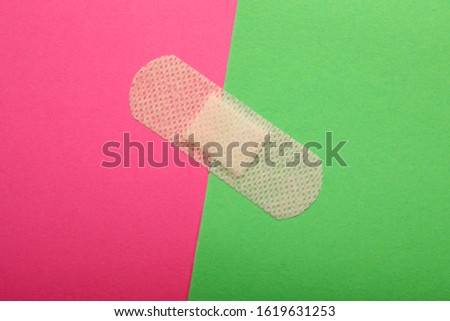 Sticking plaster on color background, top view