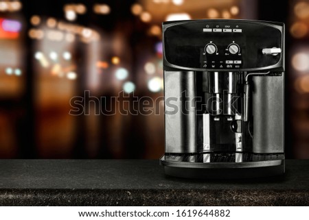 Board in kitchen interior with coffee machine and free space for your decoration.Blurred background and copy space. 