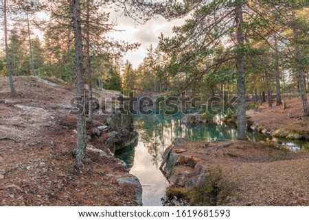Old abandoned silver mine with blue, emerald water on a sunny evening. silverberg in central Sweden. selective focus