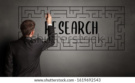 businessman drawing maze with RESEARCH inscription, business education concept
