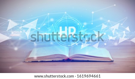Open book with HR abbreviation, modern technology concept