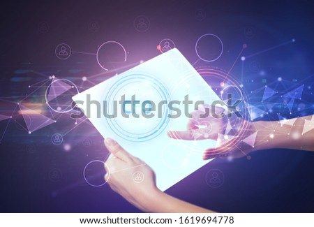Hand holdig futuristic tablet with CFO inscription, modern technology concept