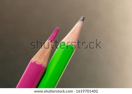 Pink pencil and green pencil