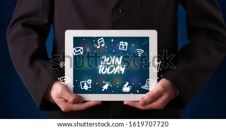 Young business person working on tablet and shows the inscription: JOIN TODAY