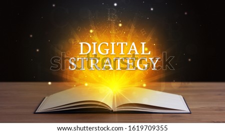DIGITAL STRATEGY inscription coming out from an open book, educational concept
