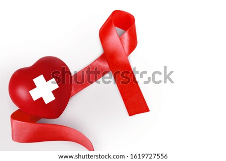 Red ribbon and red heart symbol for take care Aids awareness on white background.