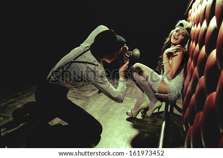 Photographer is taking a picture of a beautiful cabaret girls