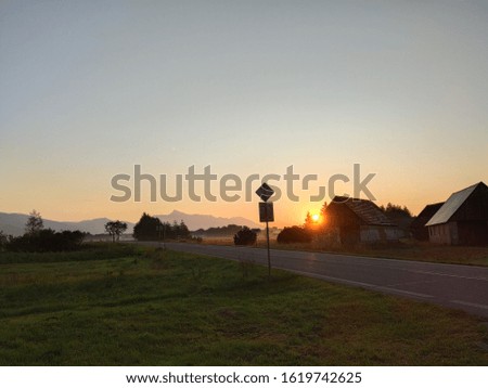 This is a picture of a sunrise near a highway.