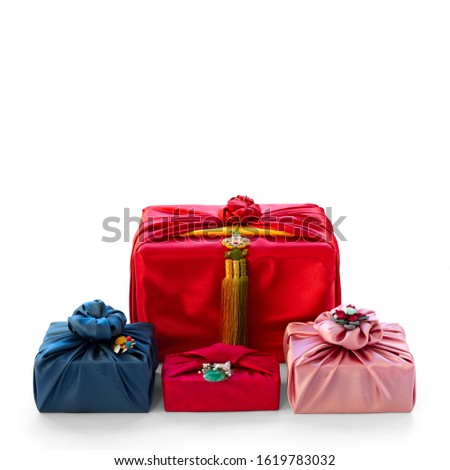 Korean traditional gift wrapping cloth made of silk(bojagi) and ornaments with copy space. Isolated on white background. Royalty-Free Stock Photo #1619783032
