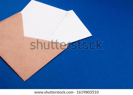 Envelope and white empty letter mockup flat lay top view with copy space. Communication, information, post, mail concept. Web, social media banner template. Stock photo